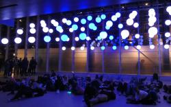 People lying down to view the bouncing lights VIVID